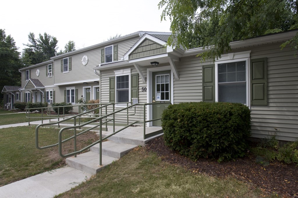 an apartment building with stairs to the front of it
