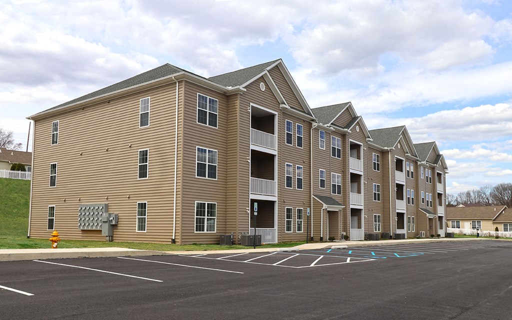 a row of apartment buildings in a parking lot