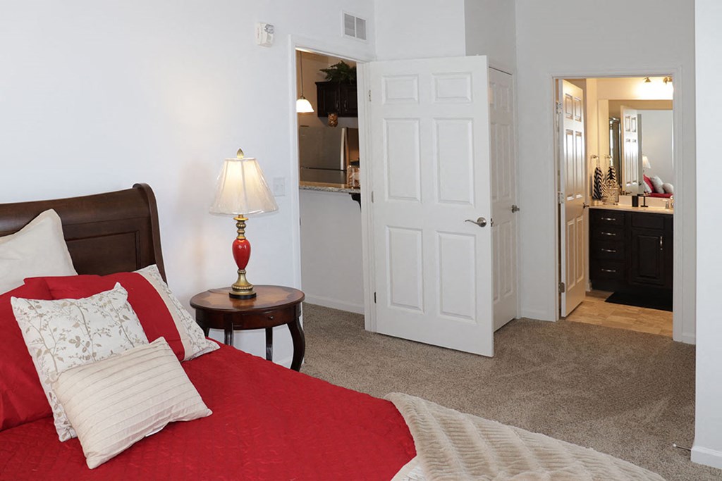 a bedroom with a bed and a bathroom