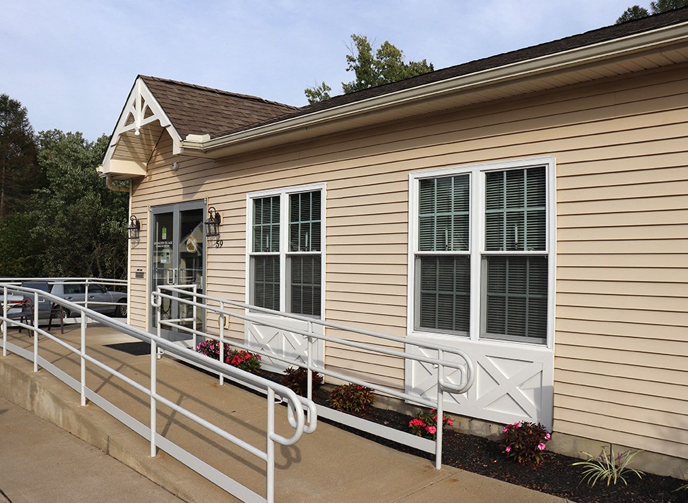 the front of a house with a ramp to the door