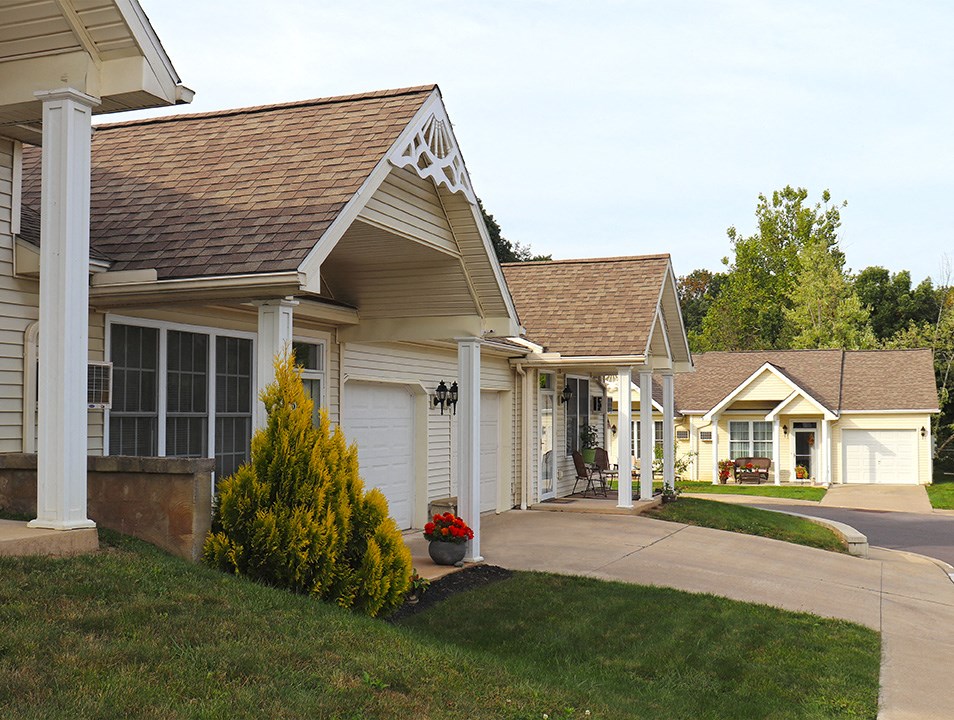 a row of houses with a sidewalk in front of them