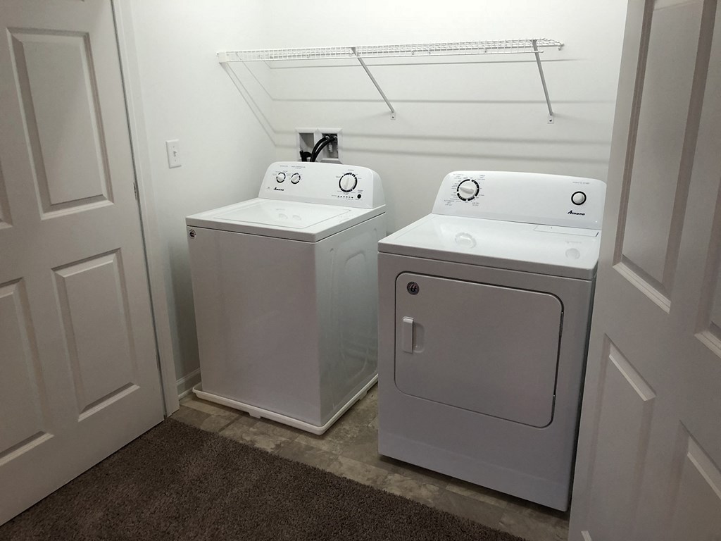 a washer and dryer in a room with a closet