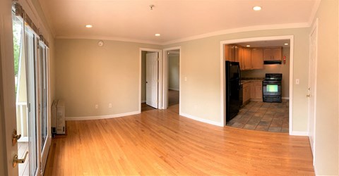 A room with wooden floors and a television in the corner.