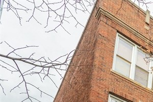 a red brick building with trees in front of it