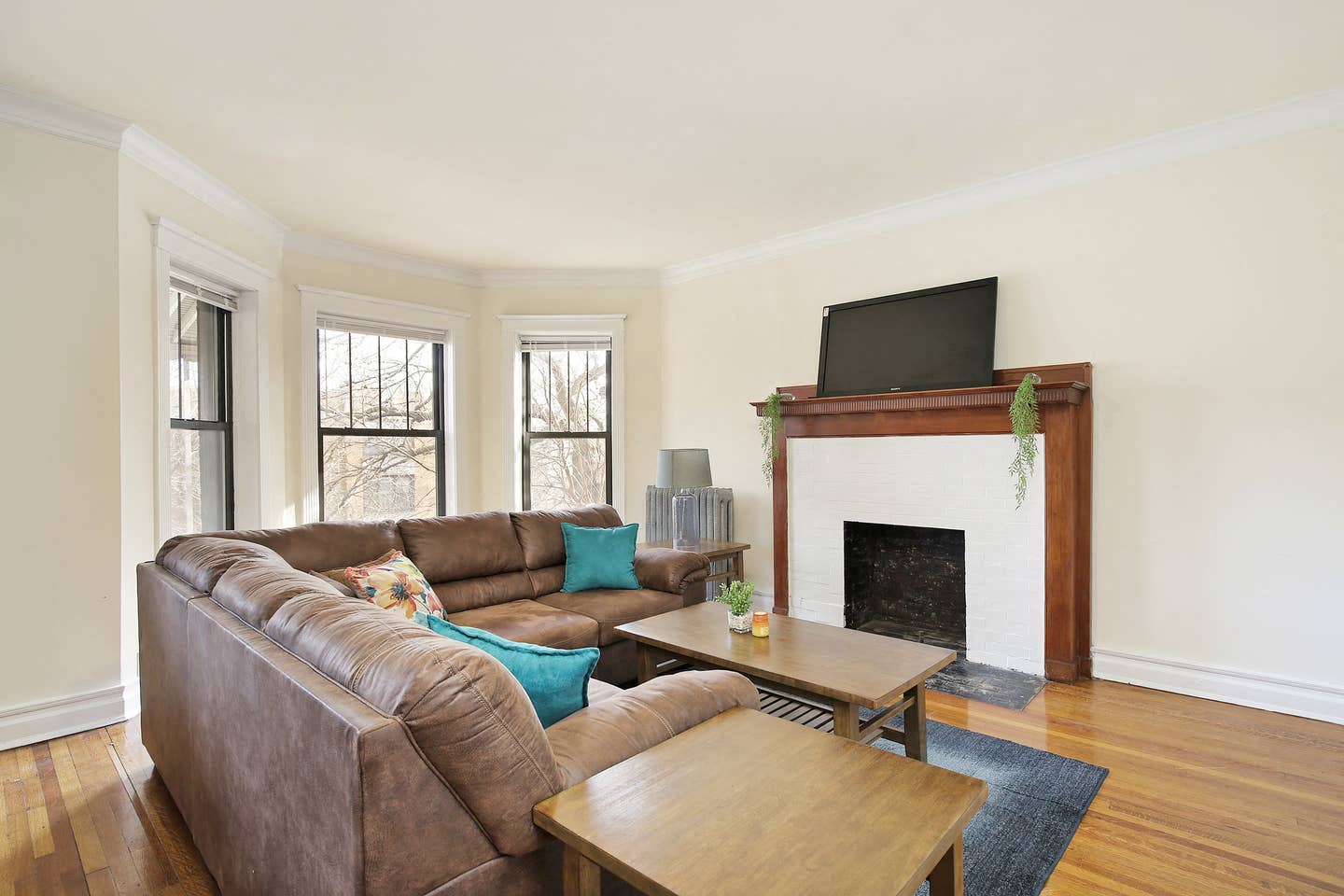 a living room with a leather couch and a fireplace