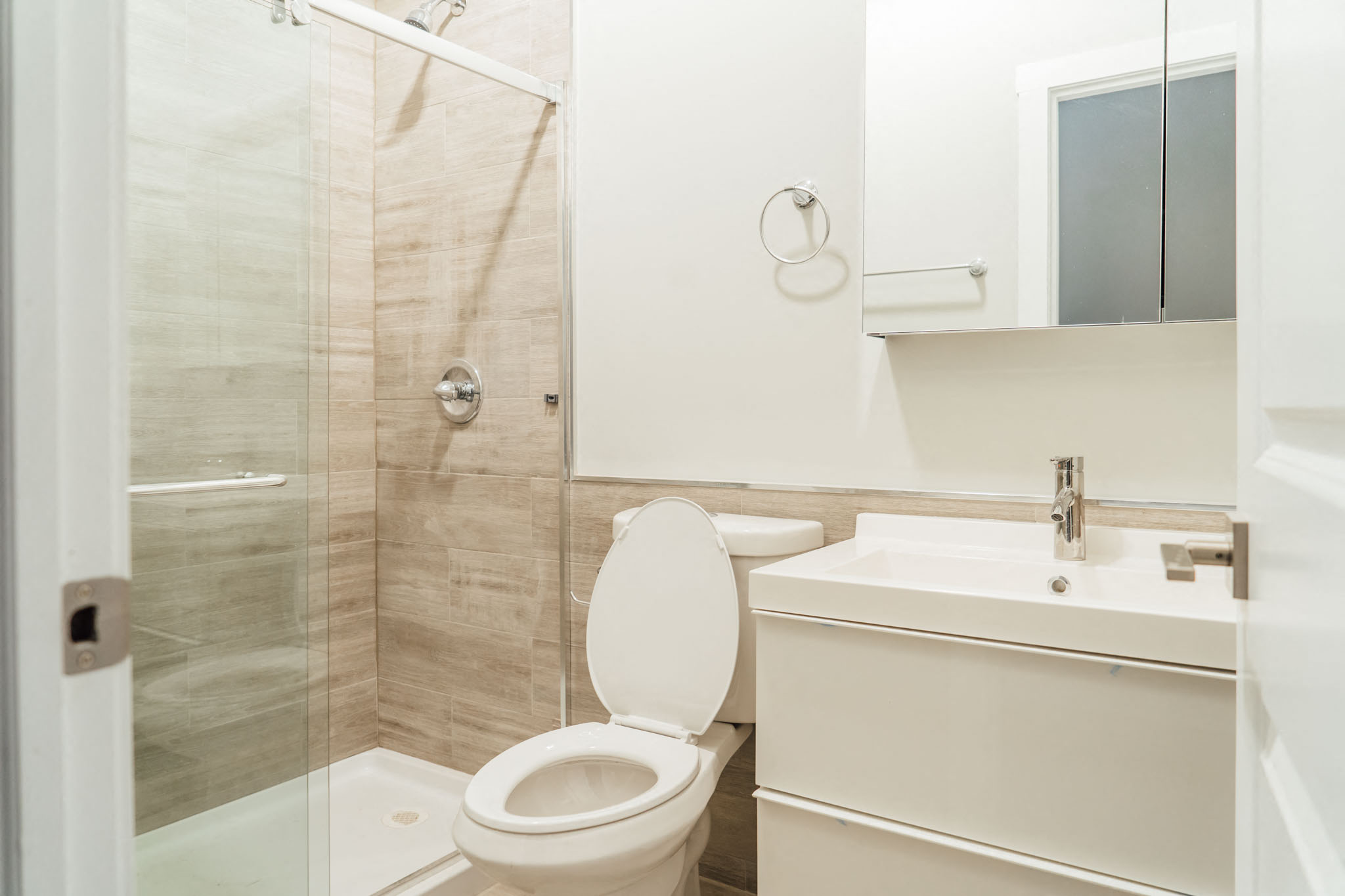 a white bathroom with a shower and a toilet