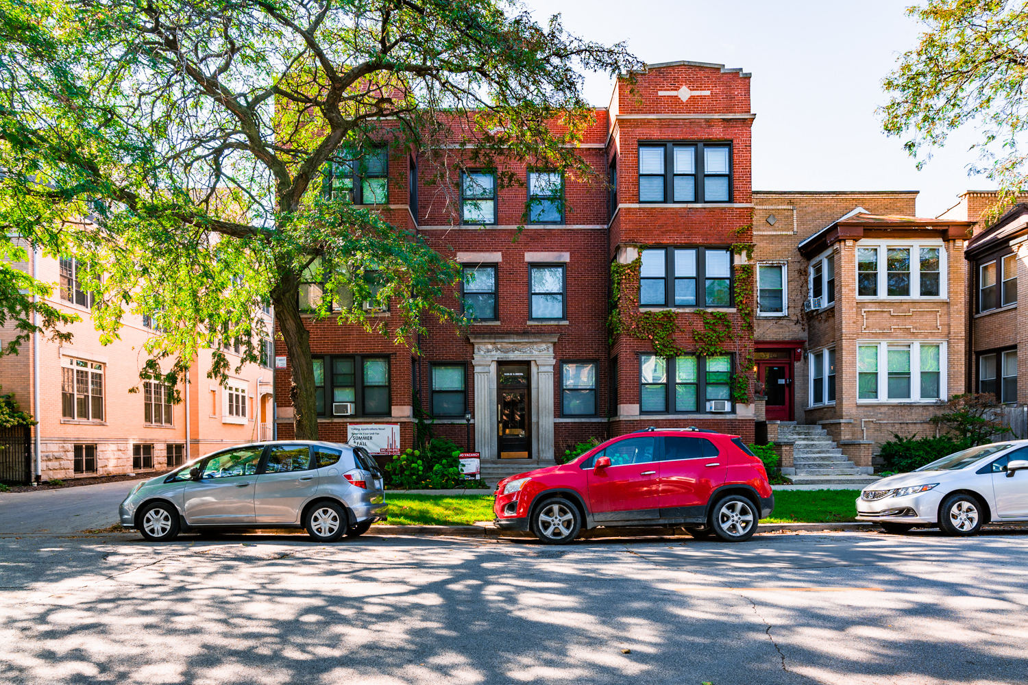 a red brick building with cars parked in front of it