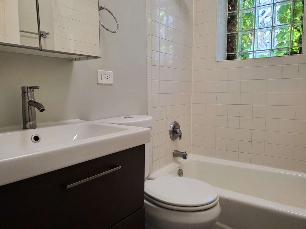 a bathroom with a toilet and a sink and a bath tub