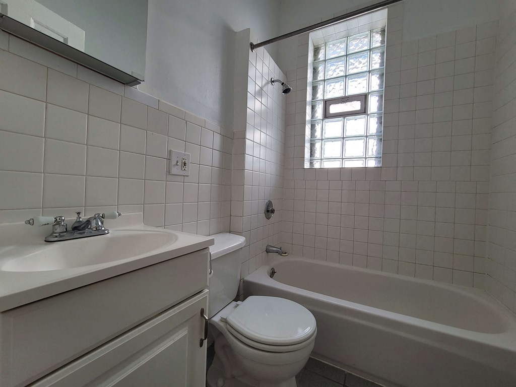 a bathroom with a sink toilet and a bath tub