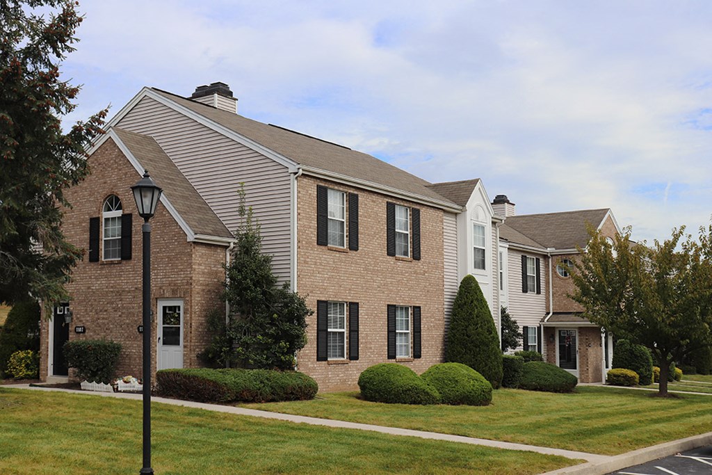 a brick house with a street lamp in front of it
