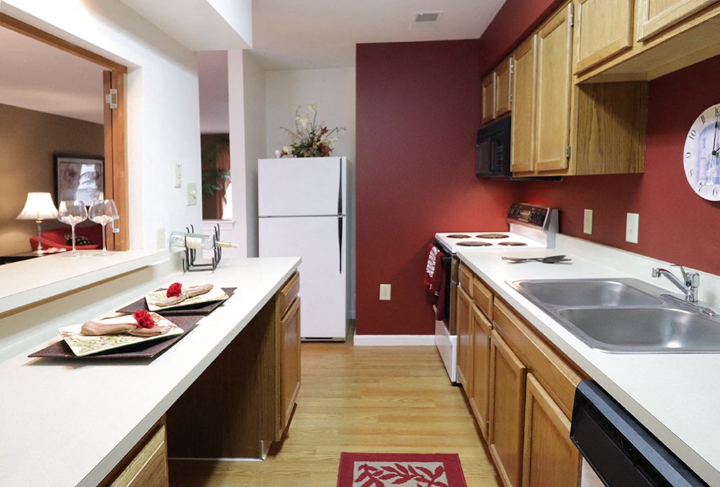a kitchen with wooden cabinets and a white counter top