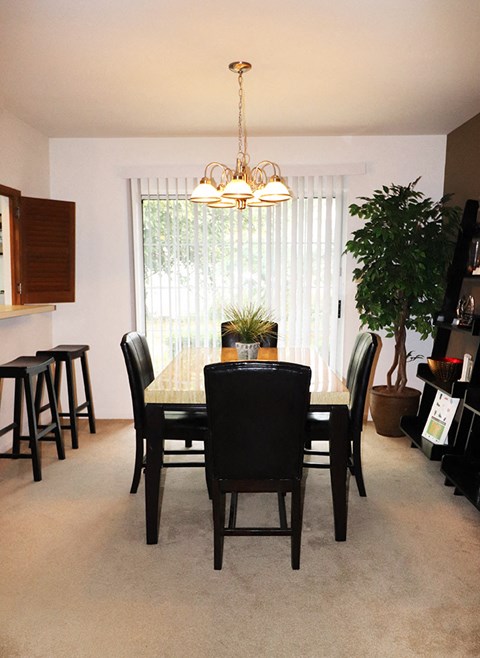 a dining room with a table and chairs