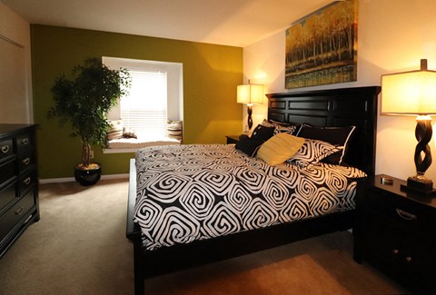 a bedroom with a large bed and a window
