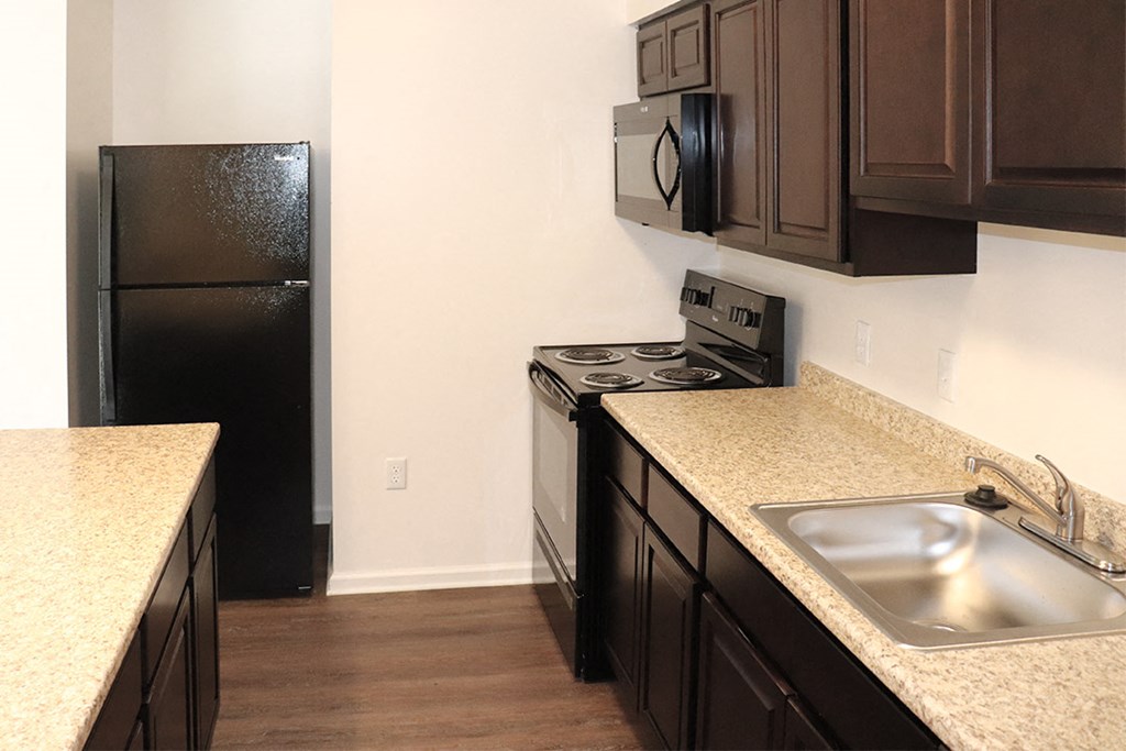 a kitchen with a sink and a refrigerator