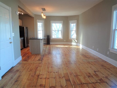 A room with wooden floors and white walls.