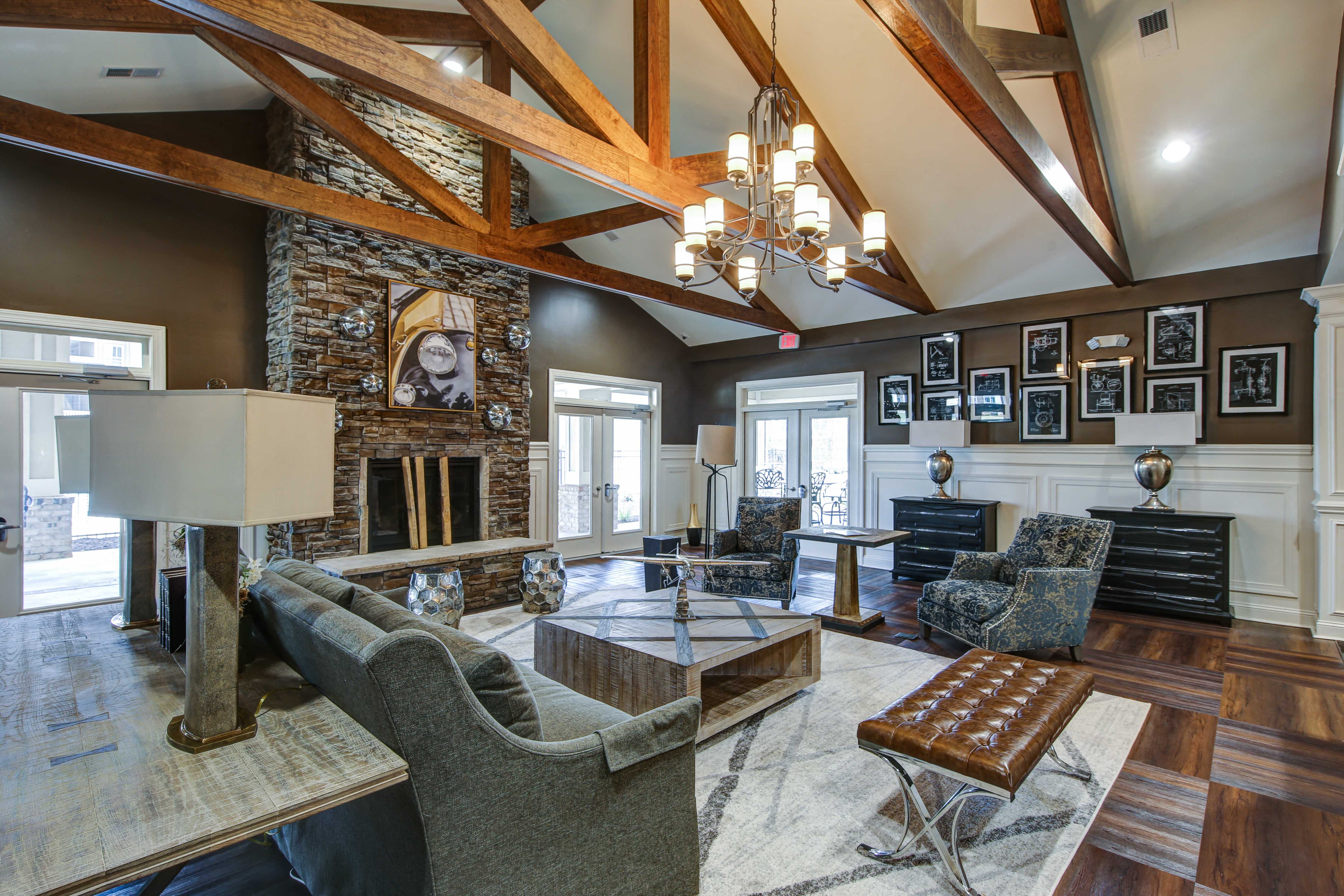 a living room with a stone fireplace and couches