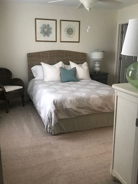 a bedroom with a bed and two pictures on the wall