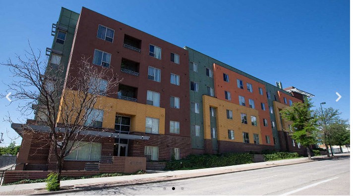 A multi-story building with a mix of red and yellow facades.