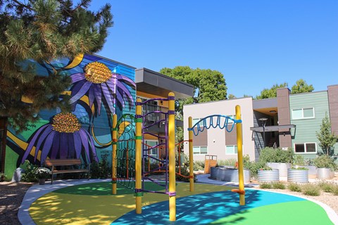 A playground with a slide and a climbing frame.