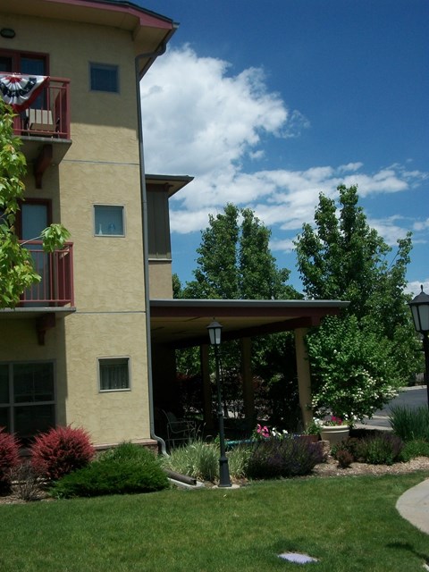 A building with a balcony and a small porch.