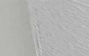 an empty living room with white walls and a ceiling fan