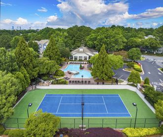 an aerial view of a tennis court and a swimming pool