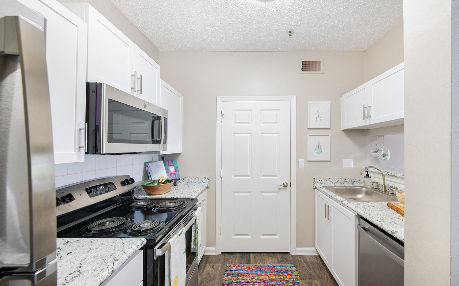a kitchen with stainless steel appliances and white cabinets