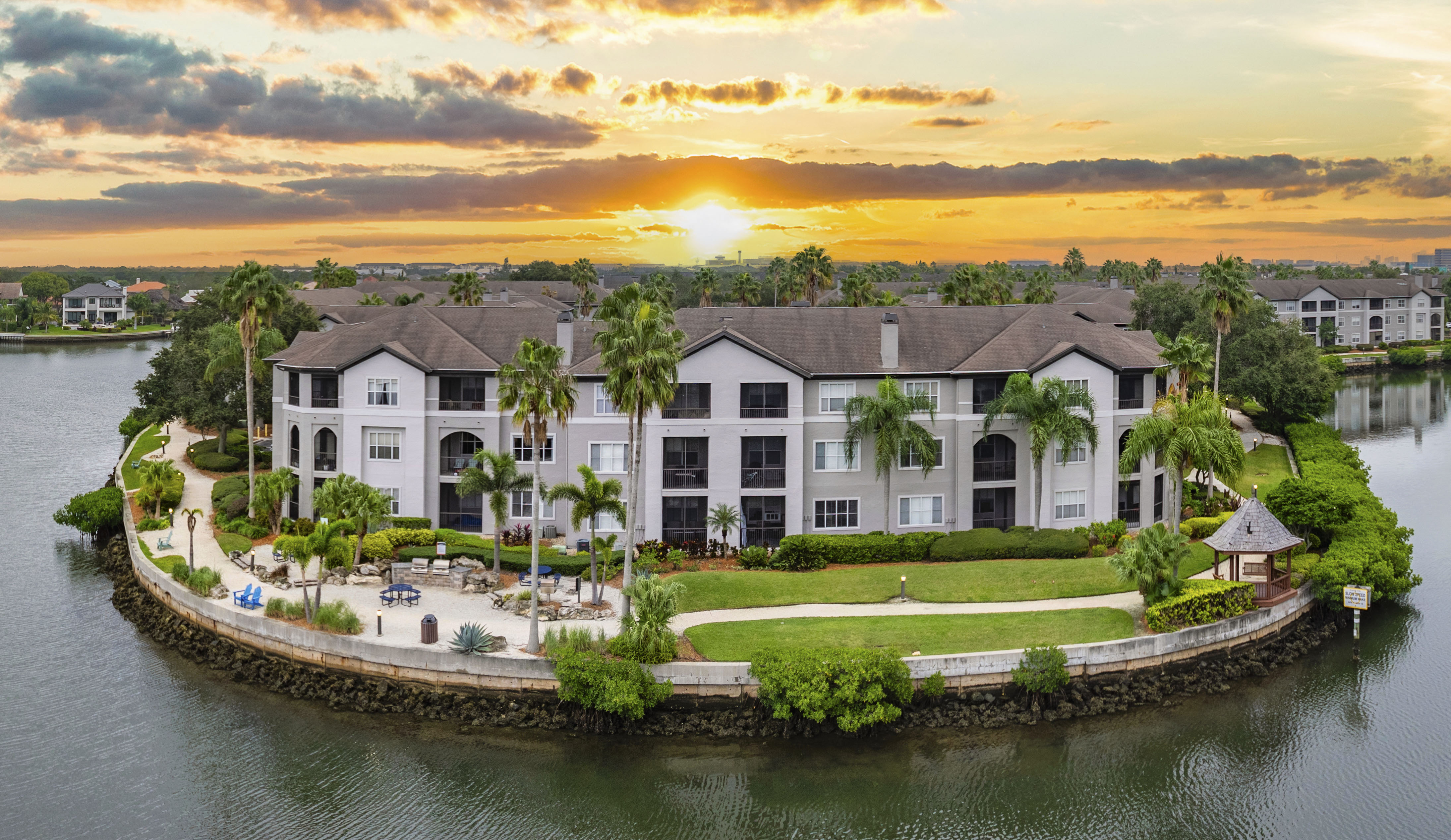 an aerial view of a large house on the water