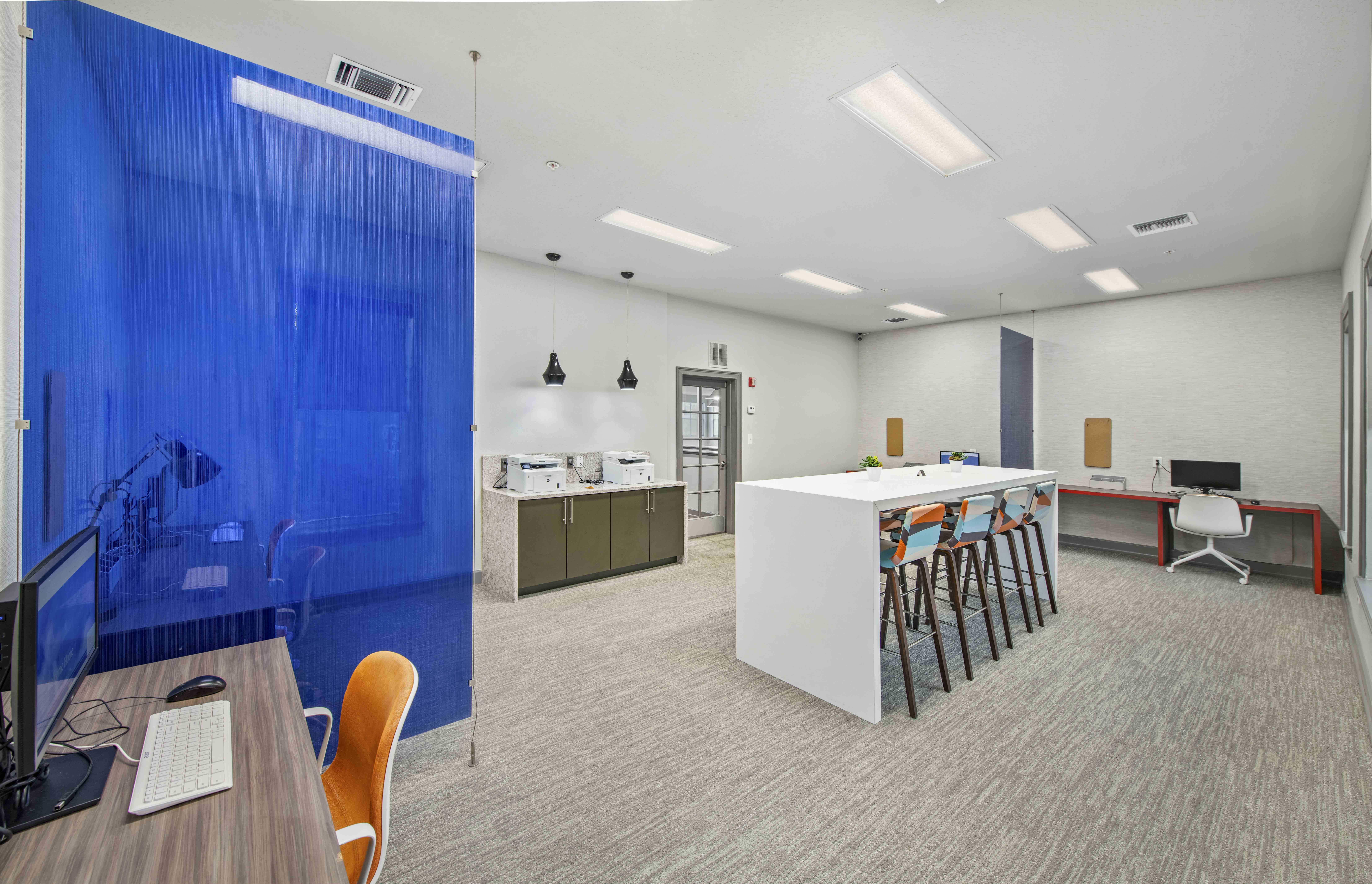 a conference room with a blue wall and a table with chairs