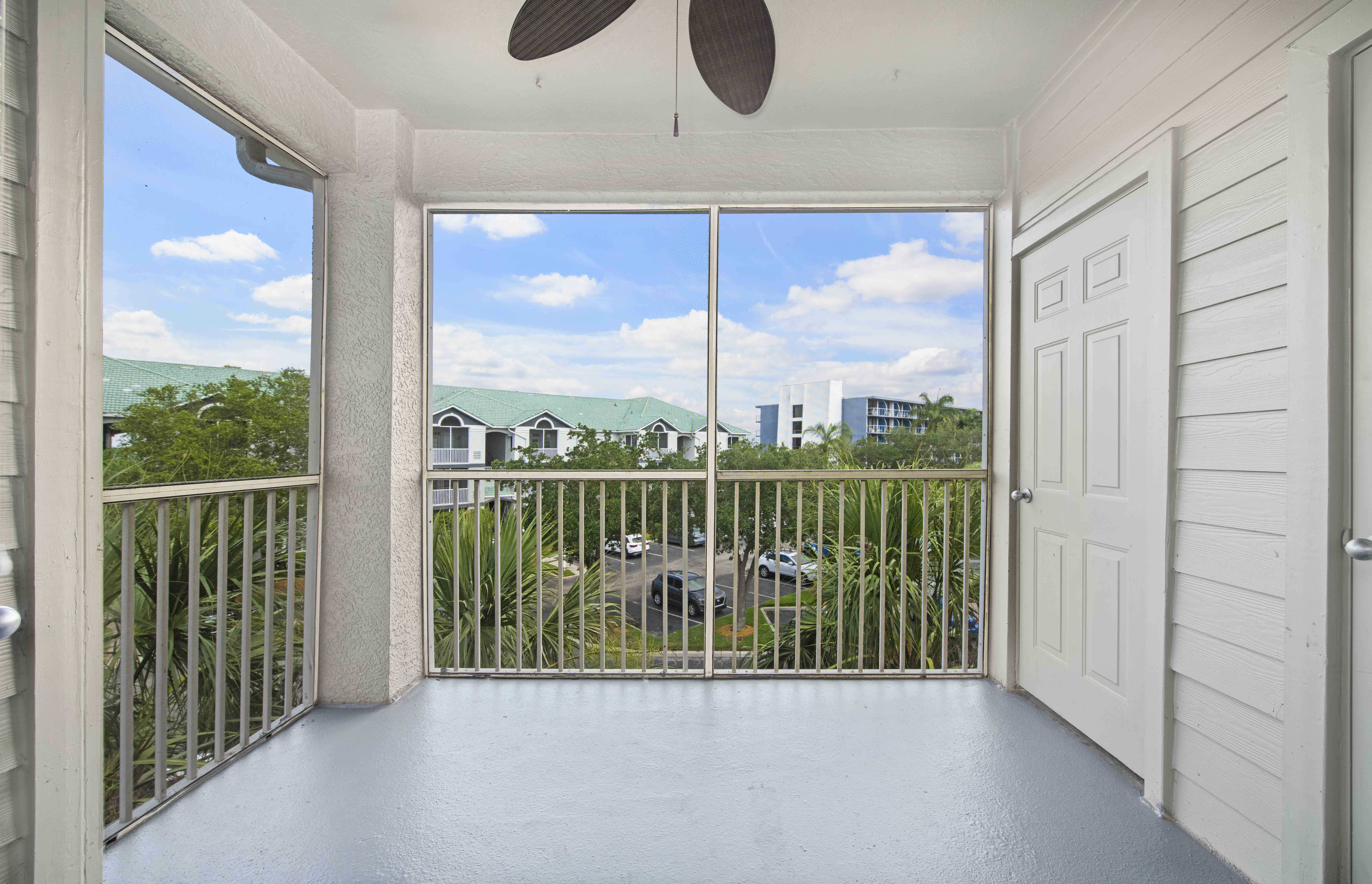 a balcony with a view of a yard and a house