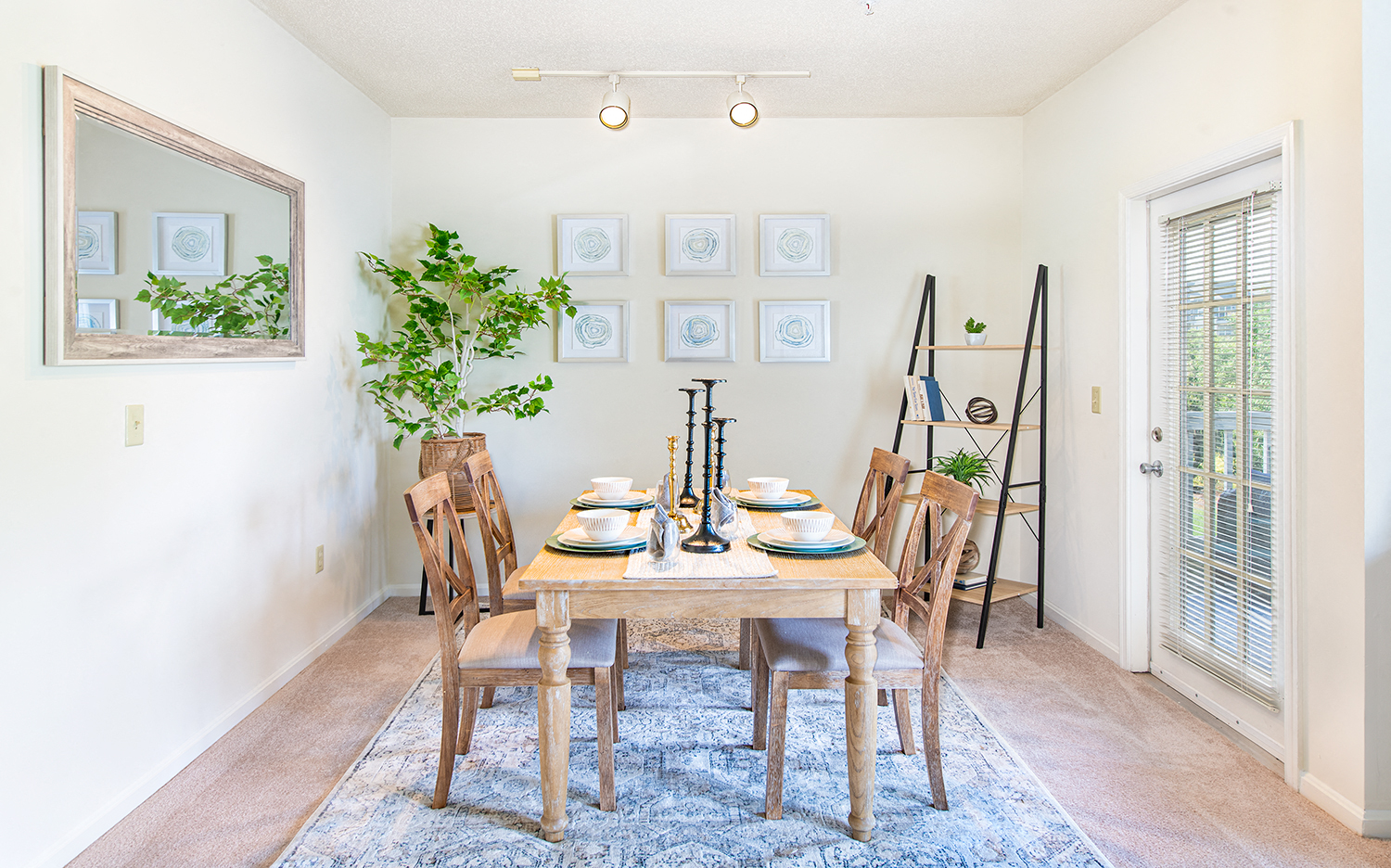 a dining room with a wooden table and chairs