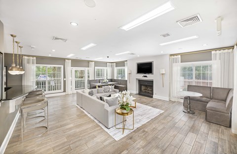 A spacious living room with a fireplace and a television.