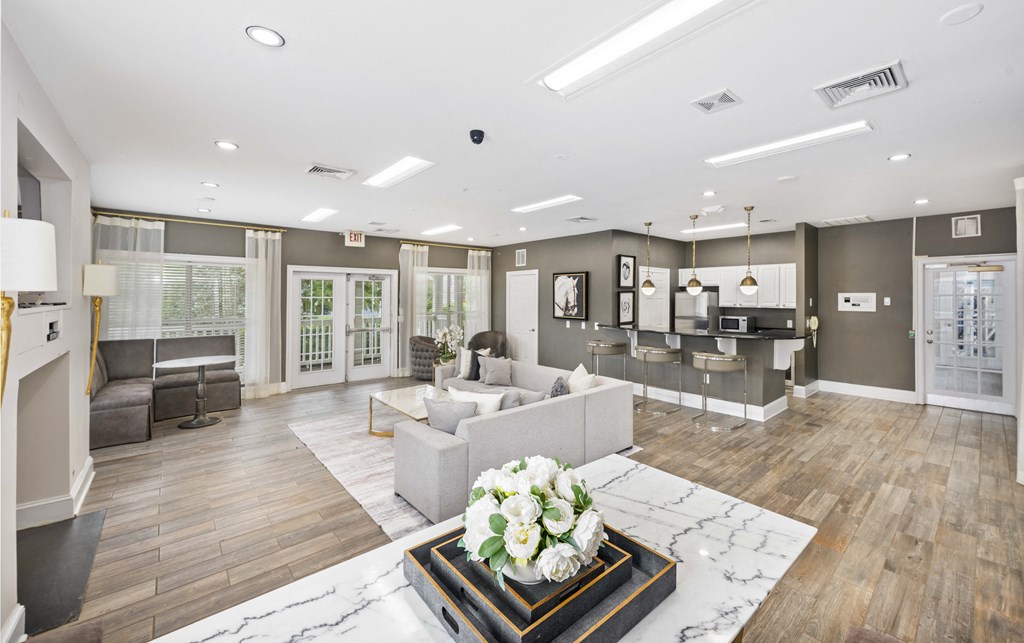 A modern living room with a marble coffee table in the center.