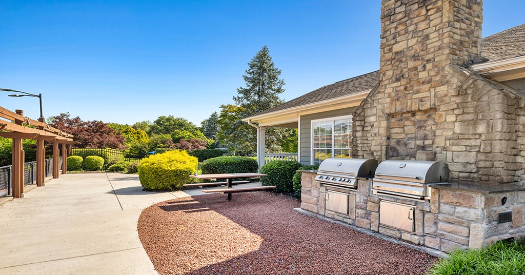 A stone chimney is on the side of a house.