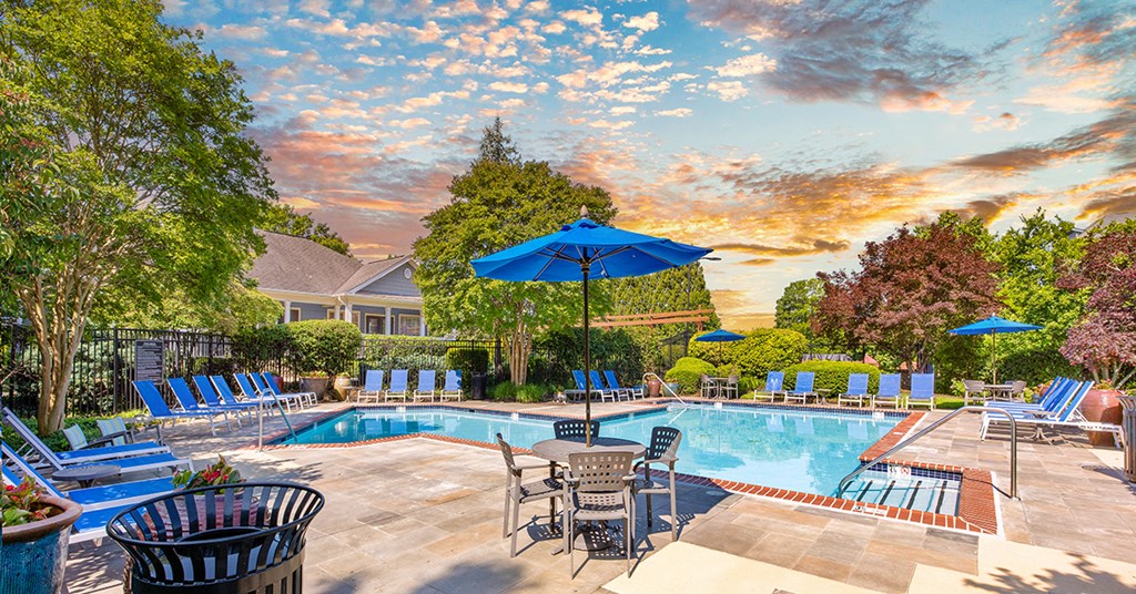 A poolside area with chairs and umbrellas is shown.