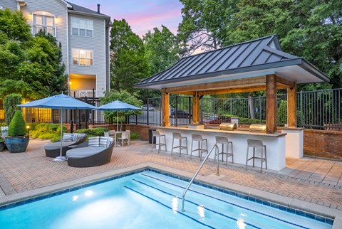 A pool area with a bar and seating area.
