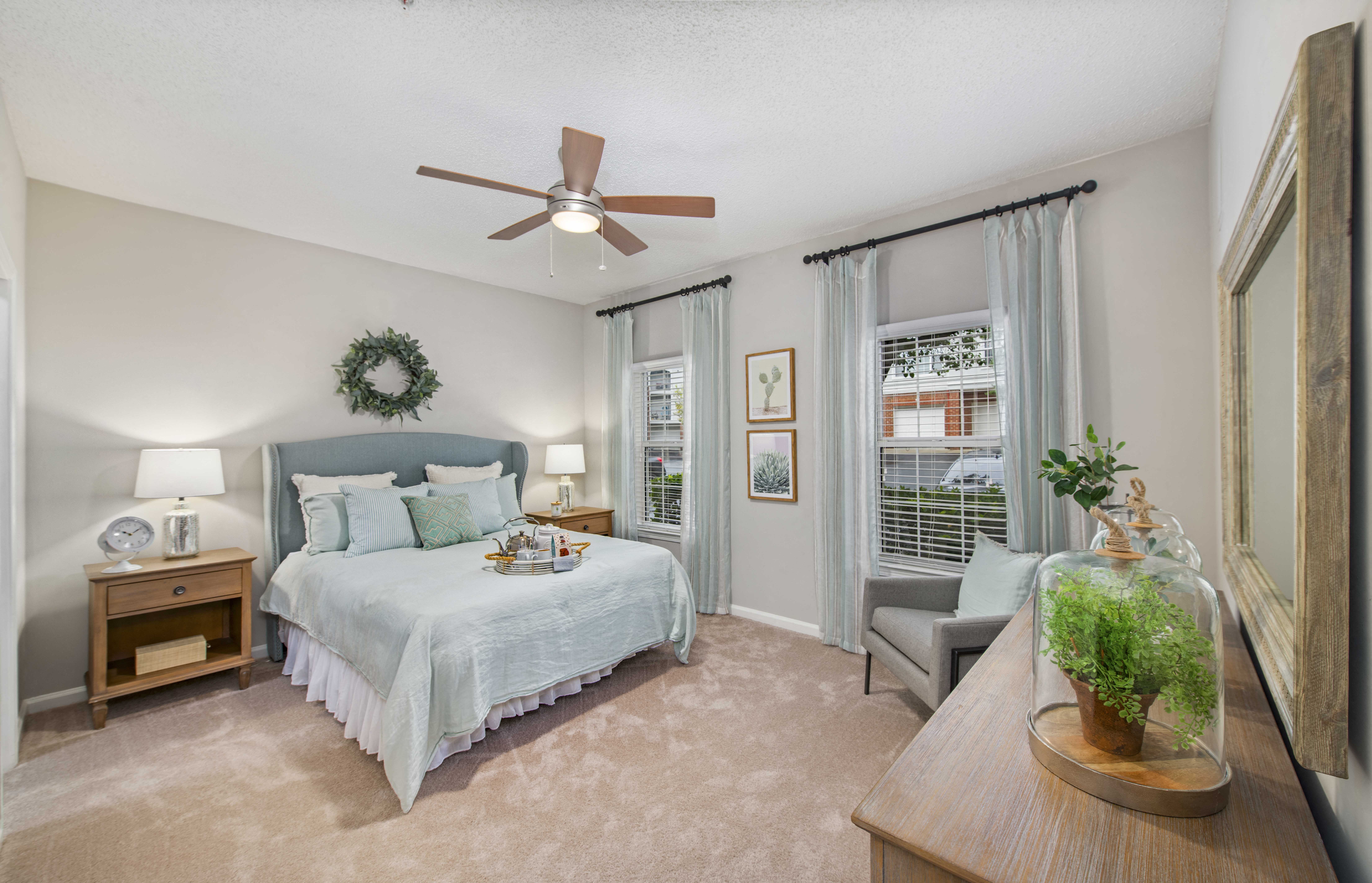 a bedroom with a bed and a ceiling fan