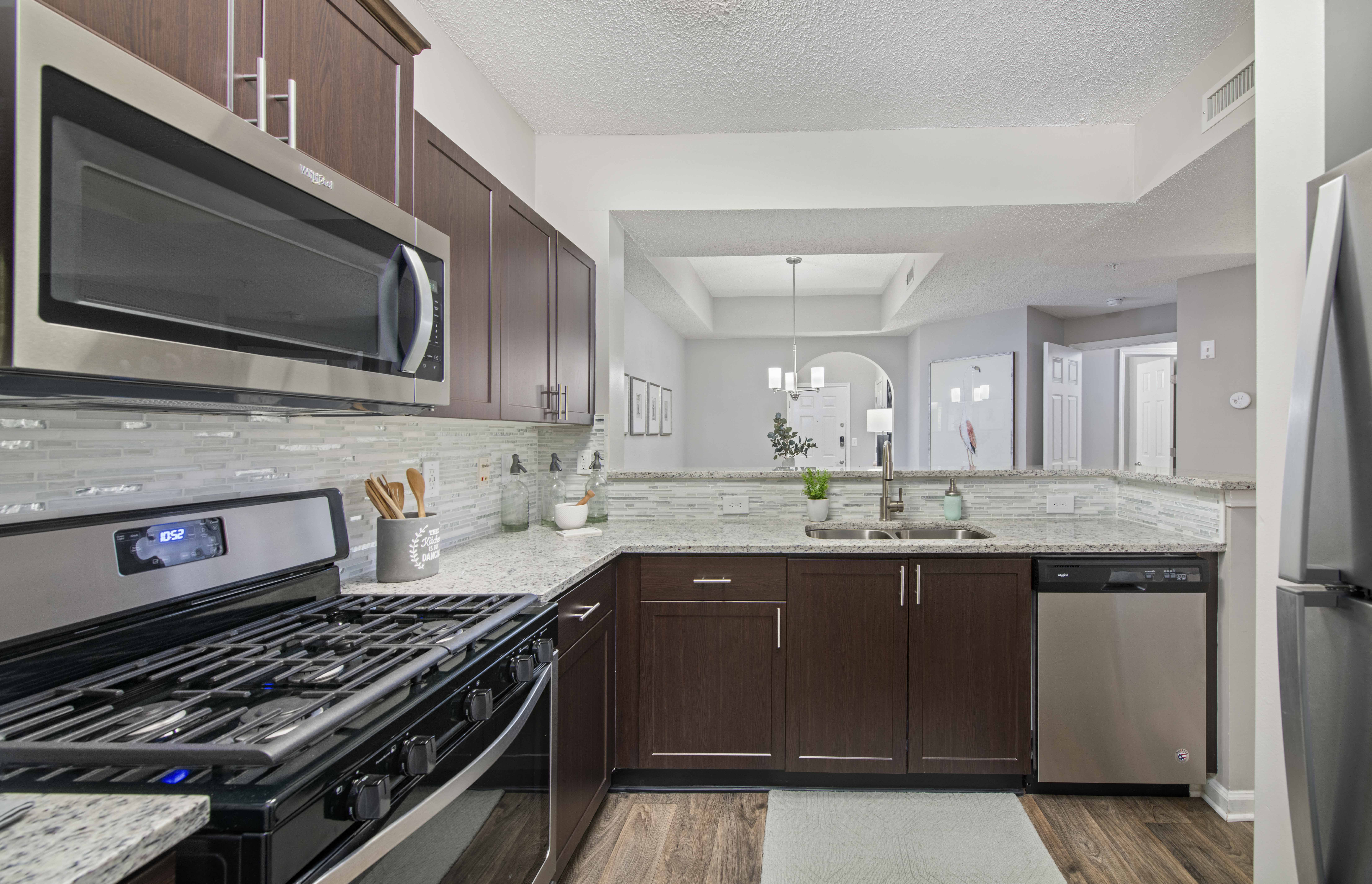 a kitchen with stainless steel appliances and marble counter tops