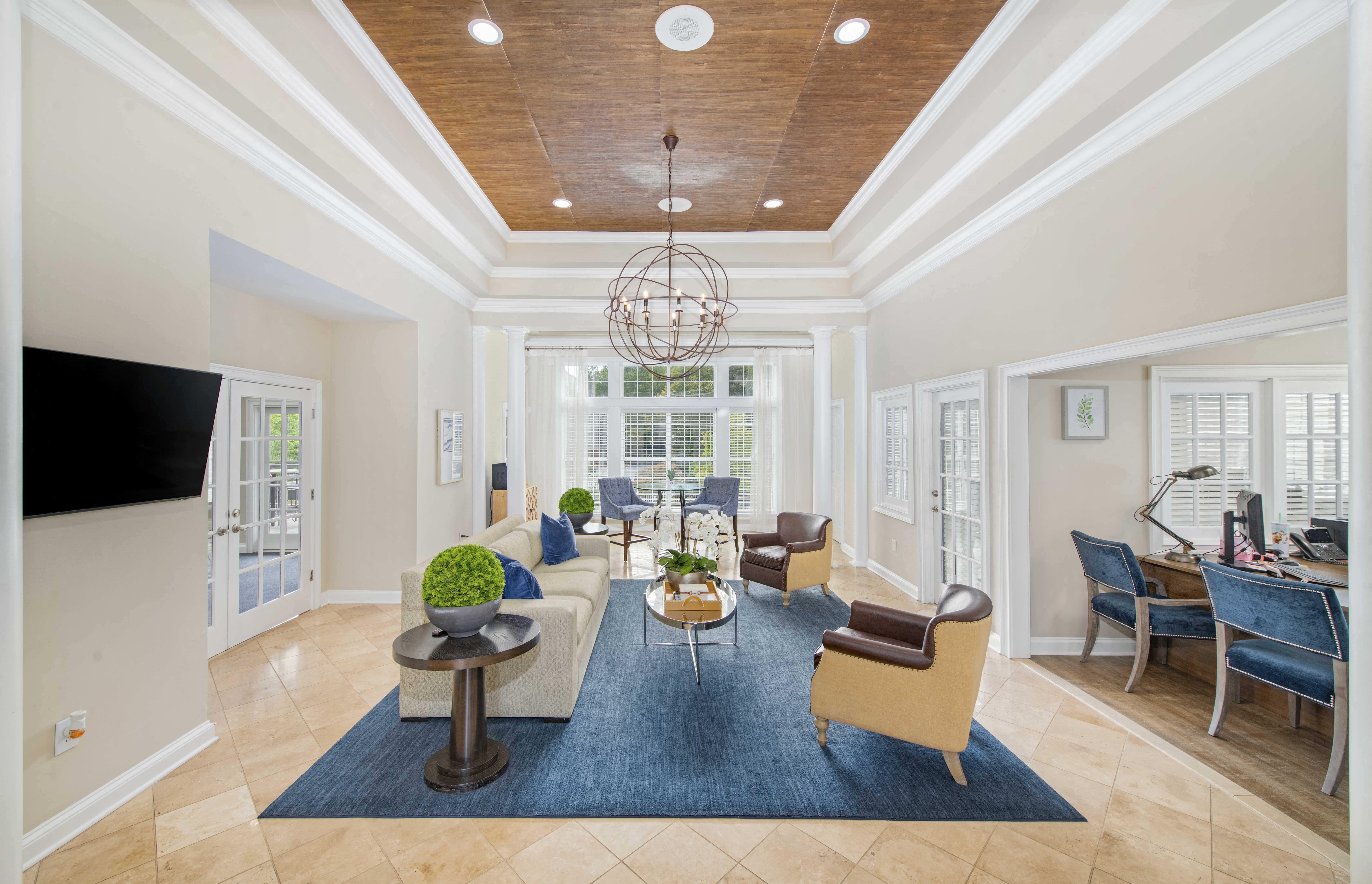 a living room with a couch and chairs and a table