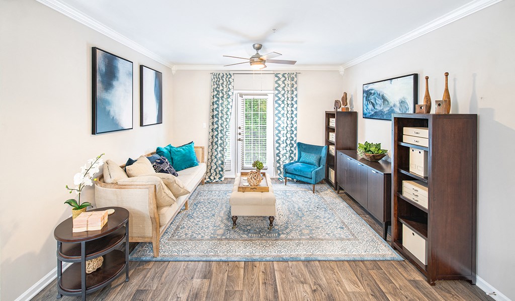 a living room with furniture and a ceiling fan