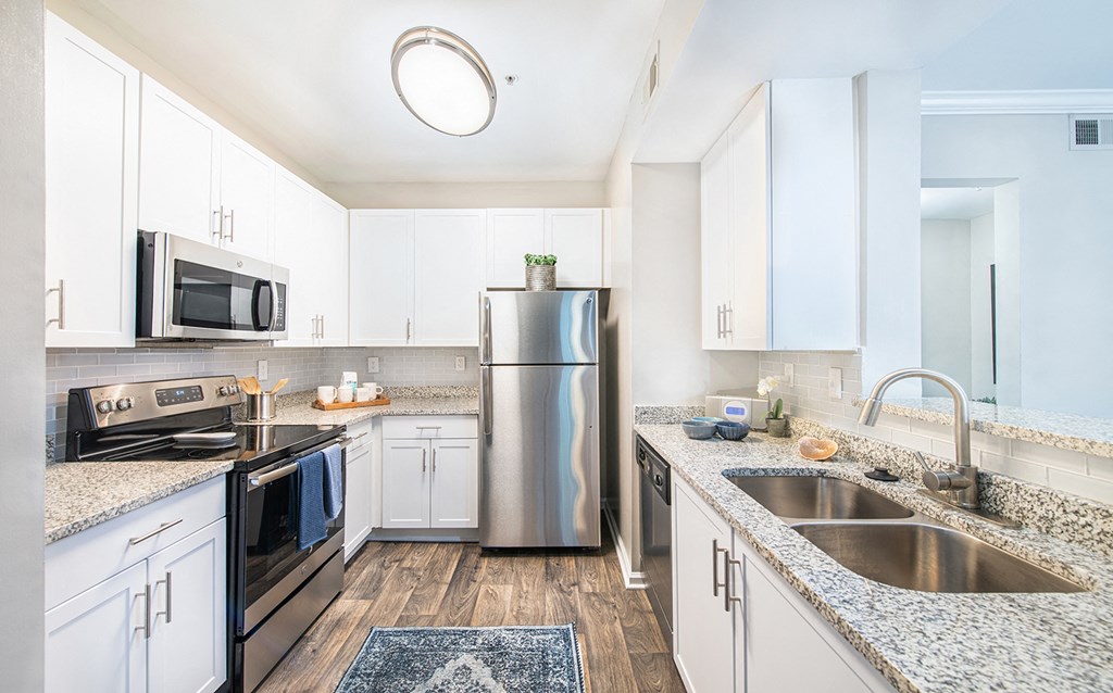 a modern kitchen with granite counter tops and stainless steel appliances