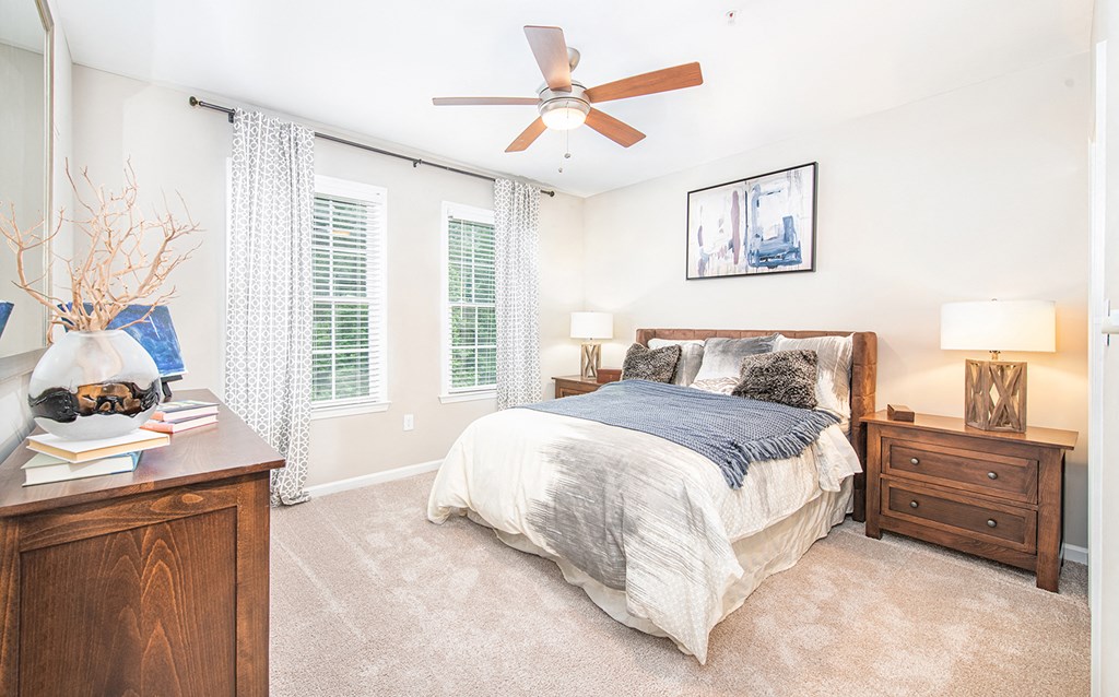 a bedroom with a large bed and a ceiling fan