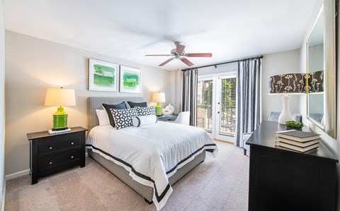 a bedroom with a large bed and a ceiling fan