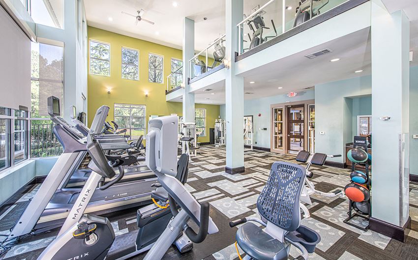 a gym with cardio machines and weights at the enclave at woodbury