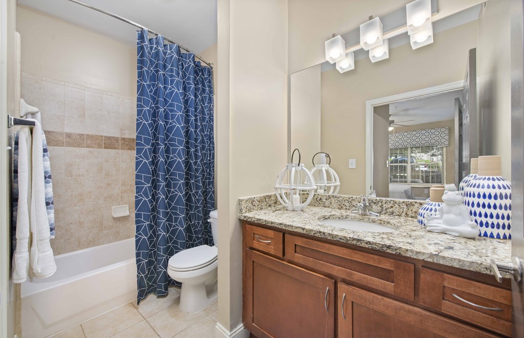 a bathroom with a shower and a sink and a toilet