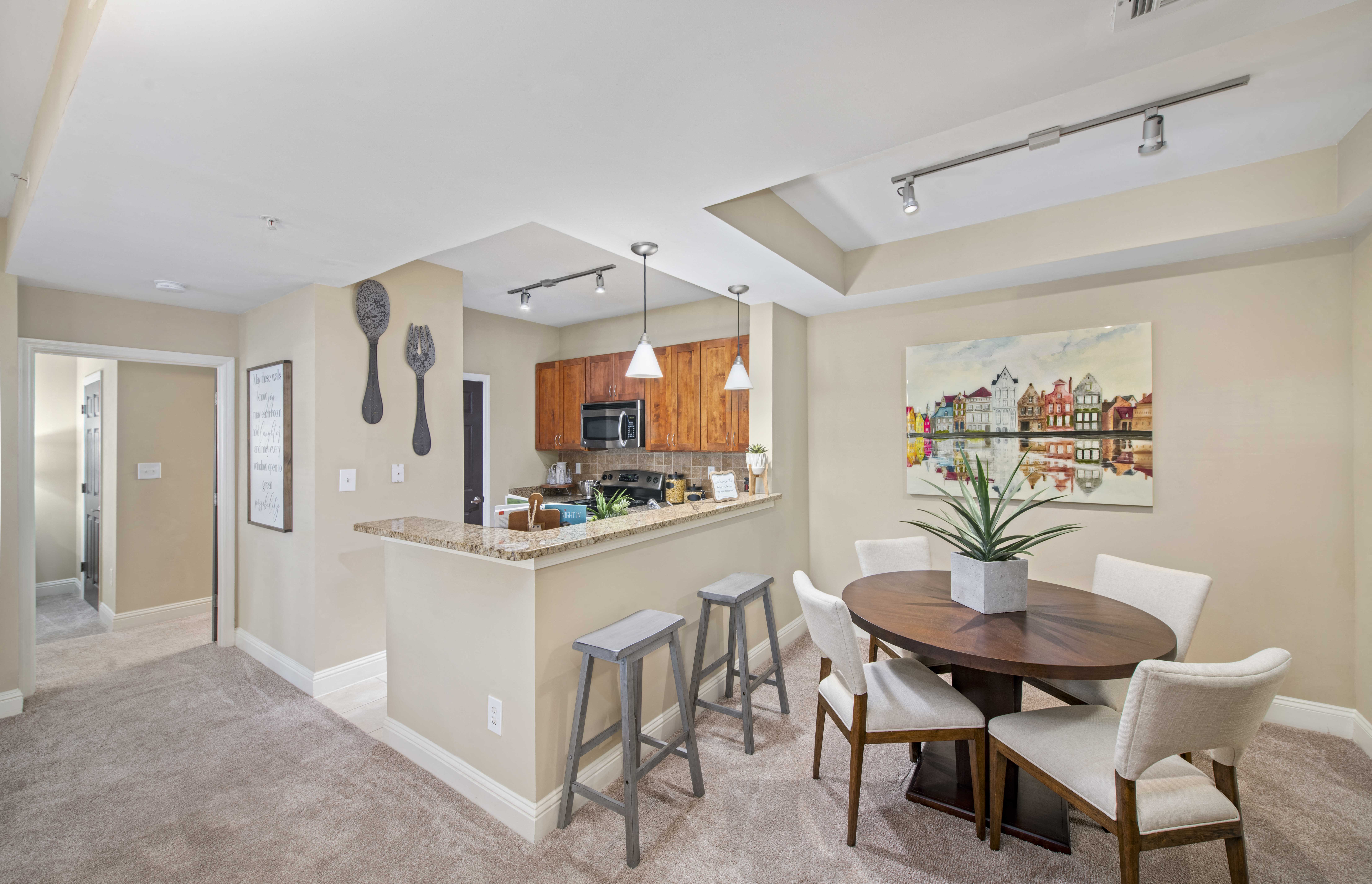 a dining area with a table and chairs next to a kitchen