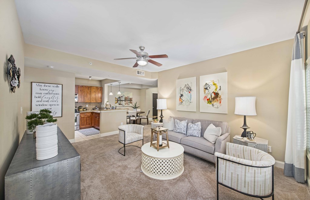 a living room with furniture and a ceiling fan
