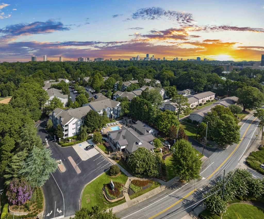 an aerial view of a neighborhood of houses with a sunset in the sky