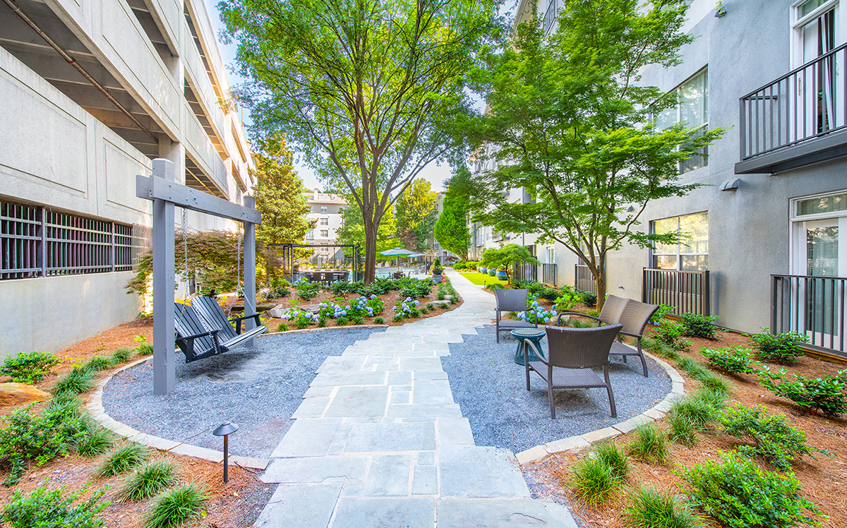 a courtyard with a table and chairs in front of a building