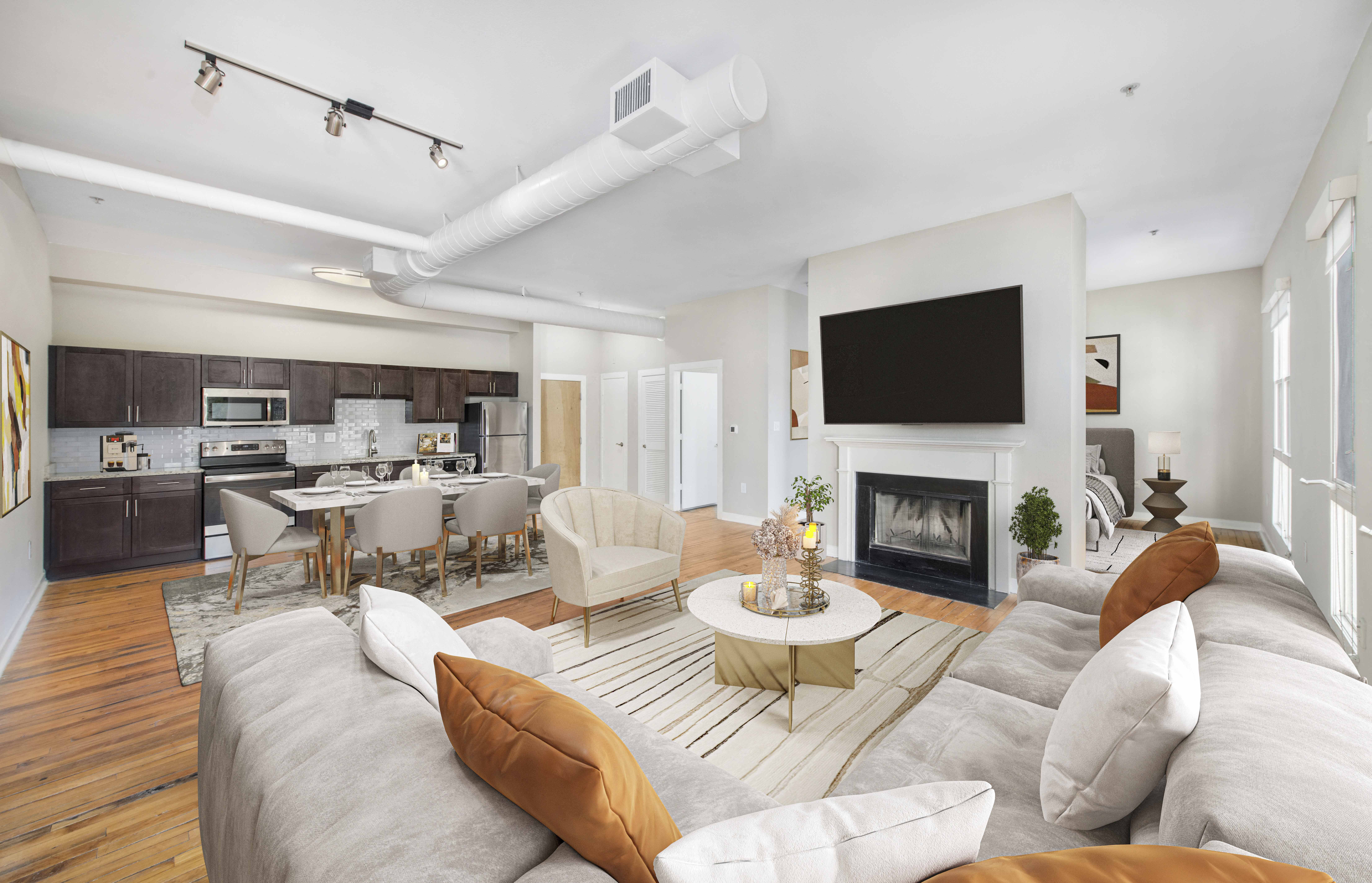 a living room with a couch and a table and a fireplace